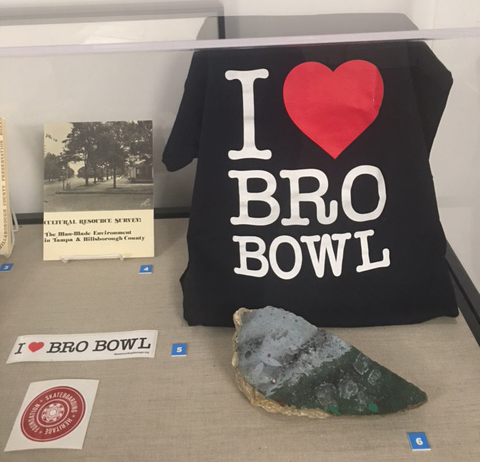 A t-shirt and bumper sticker advocating to save the “Bro Bowl” as well as a piece of concrete from the historic skatepark.