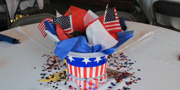 Upside down American flag hat with flags inside resting on a table graphic