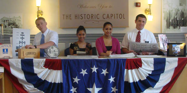 Four people sitting at a table with an american flag motif
